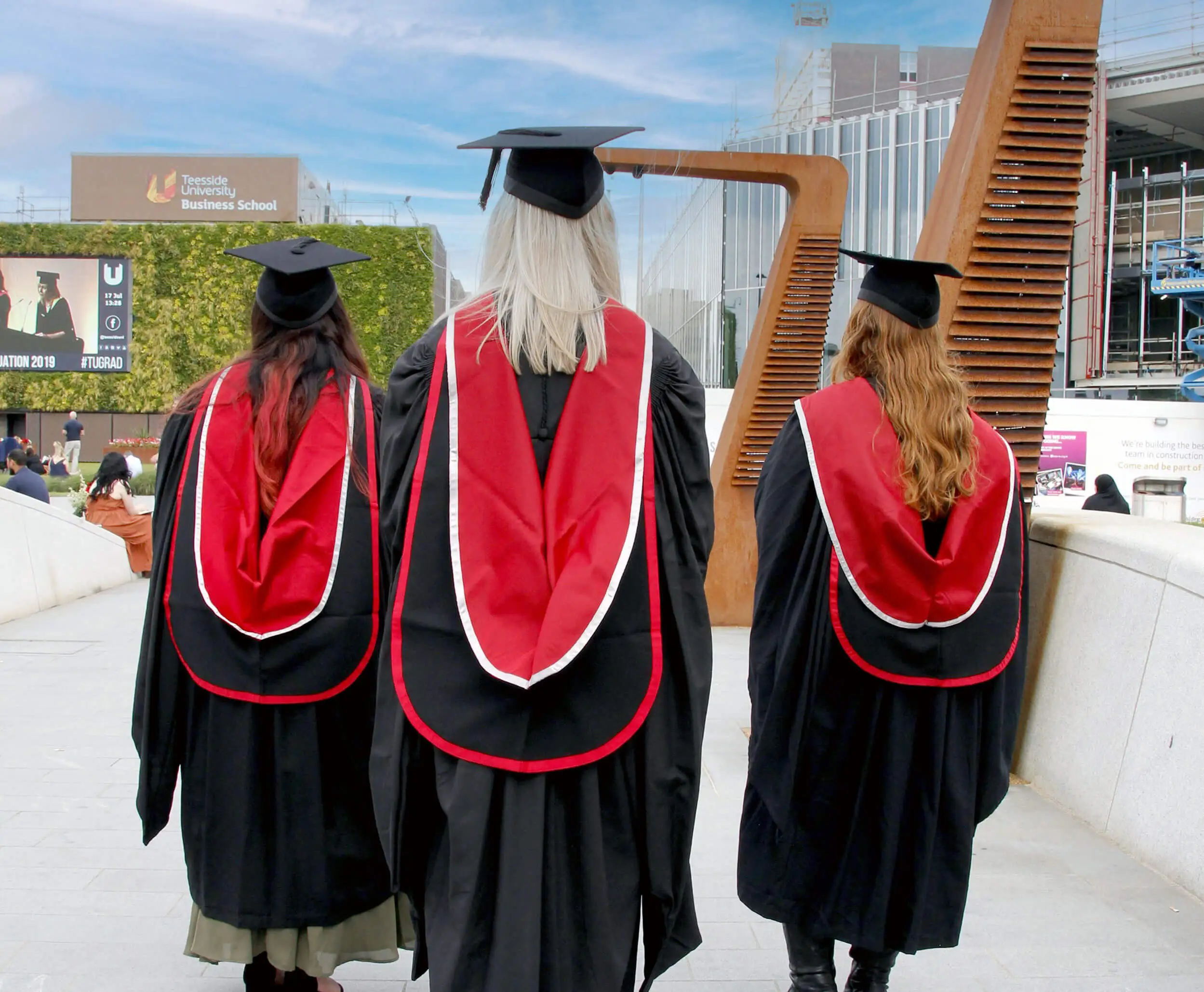 Monika and two friends at their graduation at Teesside University.